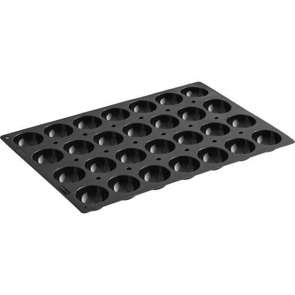 A black de Buyer semi-sphere silicone baking mold with holes in it.