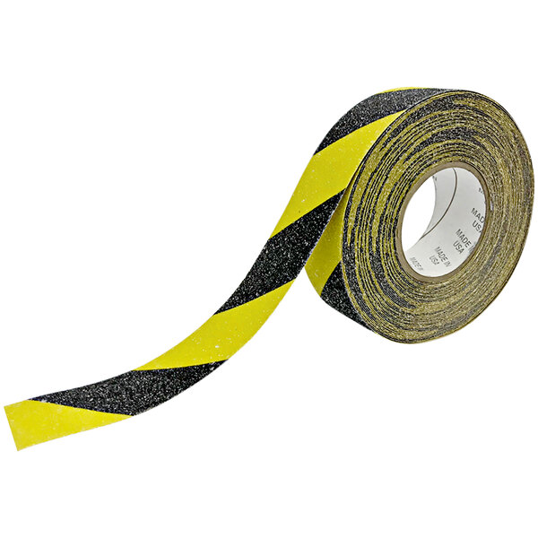 A roll of yellow and black tape with black stripes.