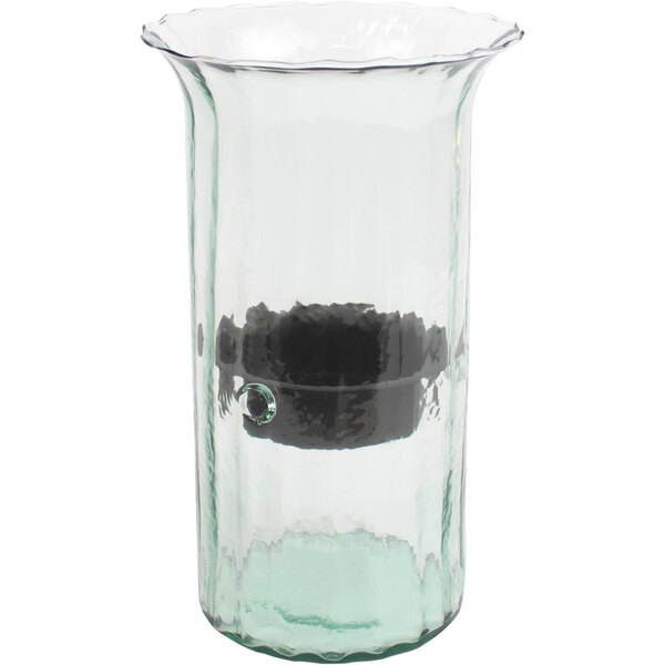 A glass vase with a black metal object inside.