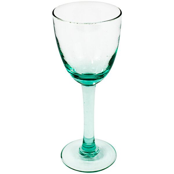A clear wine glass with a green rim.