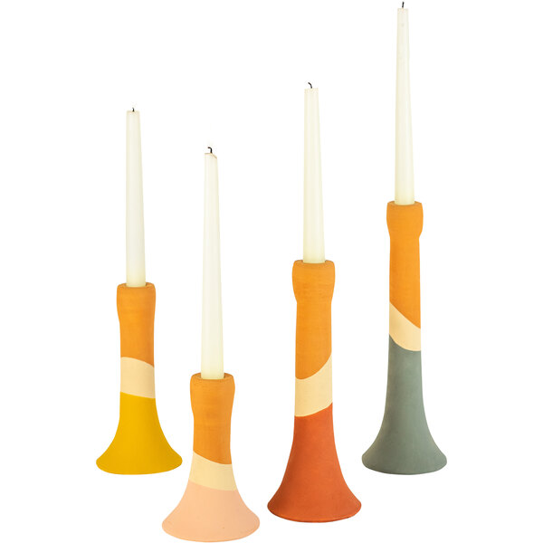 A group of Kalalou clay candle holders with different colored candles.