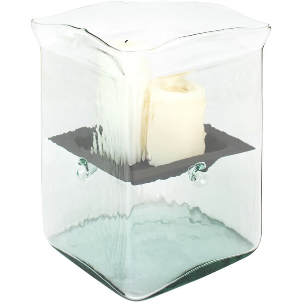 A Kalalou glass square hurricane candle holder with white candles inside.