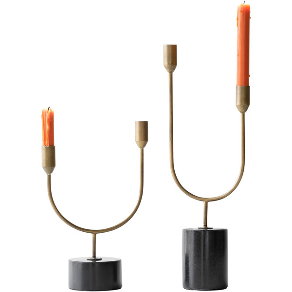A pair of Kalalou brass candlesticks with two tiers holding orange candles.