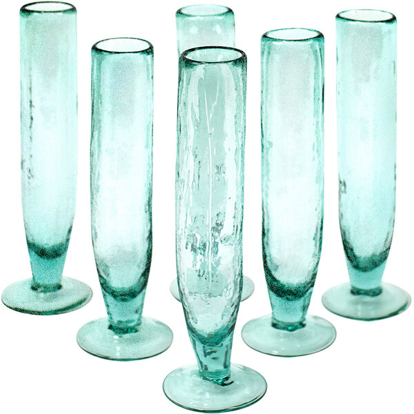 Six tall clear glass vases with a blue rim.