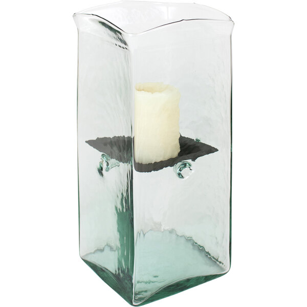 A Kalalou glass square hurricane candle holder with a lit candle inside.