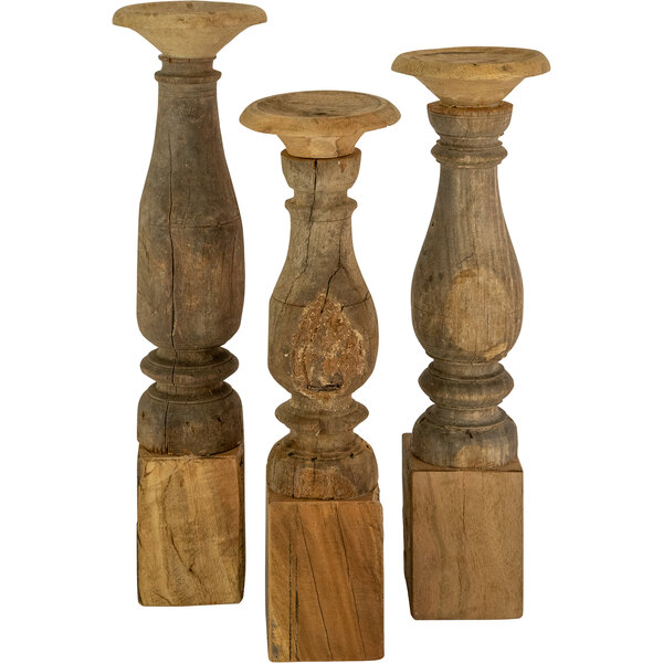 A group of three wooden Kalalou pillar candle holders with different designs.