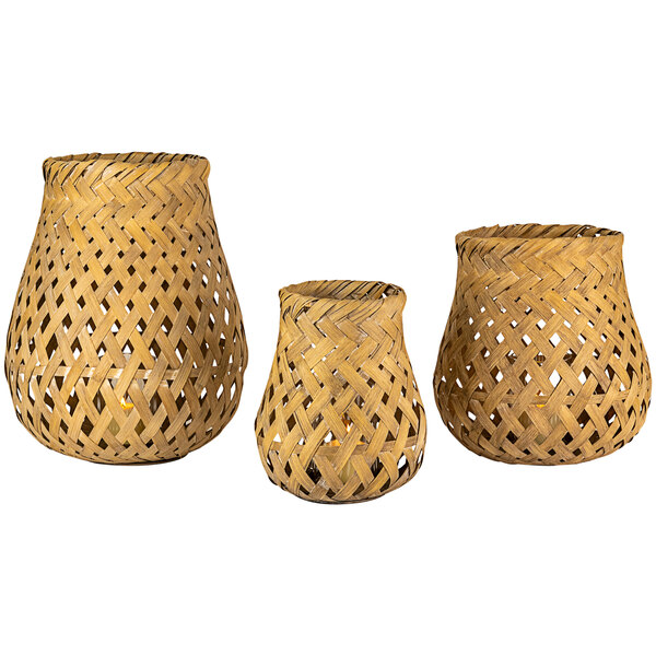A set of three woven bamboo lanterns with candles inside.