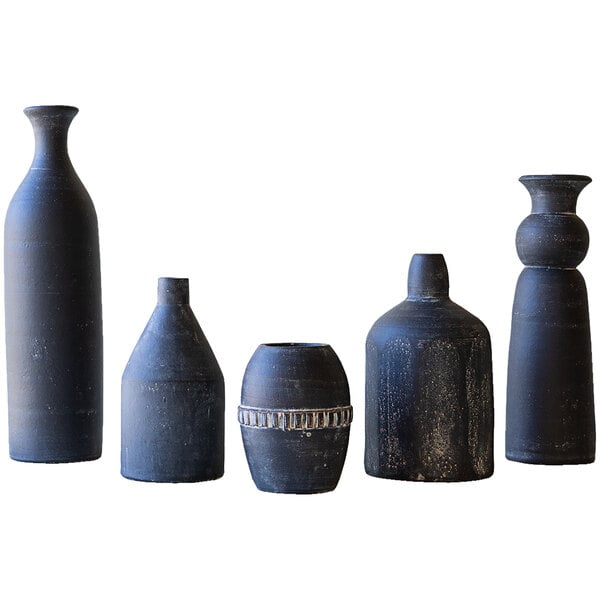 A group of black Kalalou clay vases with different designs.