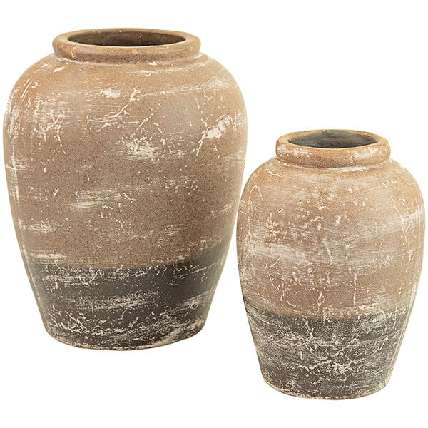 A pair of tan and white ceramic vases.