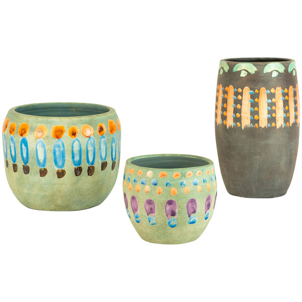 A group of three Kalalou ceramic vases in orange, green, and blue with purple dots.