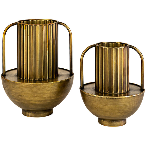 A close-up of two metal vases with handles.
