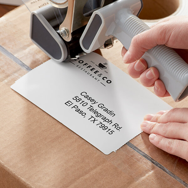A person using a Lavex white thermal transfer tag stock label stamper.