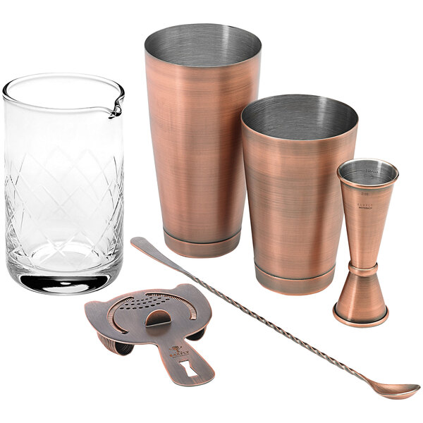 An antique copper Barfly cocktail mixing kit with copper and metal pieces.
