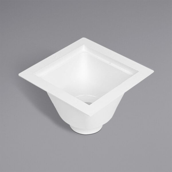 A white square PVC floor sink with a hole in the center.