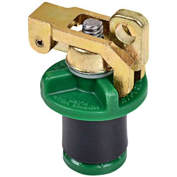 A close-up of a green and gold metal Cherne monitor well locking plug.