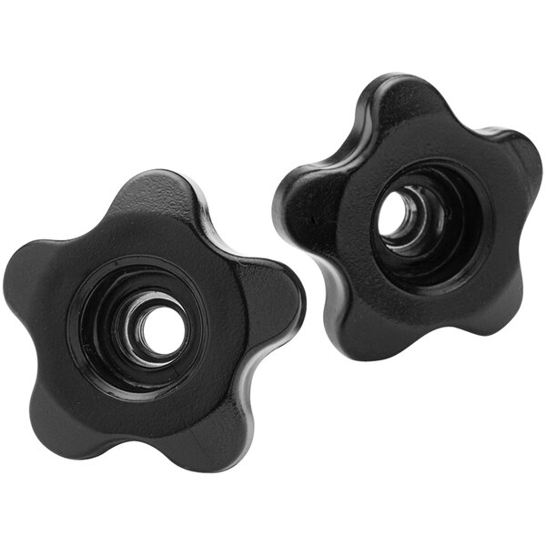 A close up of a pair of black plastic flower-shaped knobs.