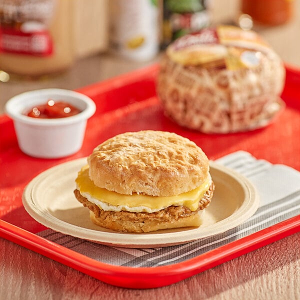 A Deli Express Sausage, Egg, and Cheese Biscuit breakfast sandwich on a plate.