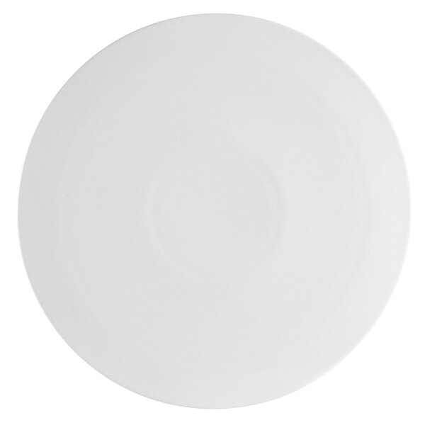 A close-up of a white plate with a white rim and a circular pattern.