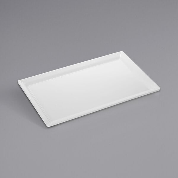 An American Metalcraft white rectangular melamine tray on a gray surface.