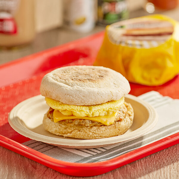 A Day 'N Night Bites Sausage, Egg, and Cheese English Muffin breakfast sandwich on a plate.