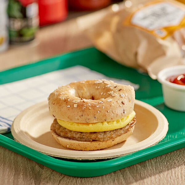 A Grand Prairie Sausage, Egg, and Cheese Bagel sandwich on a plate.