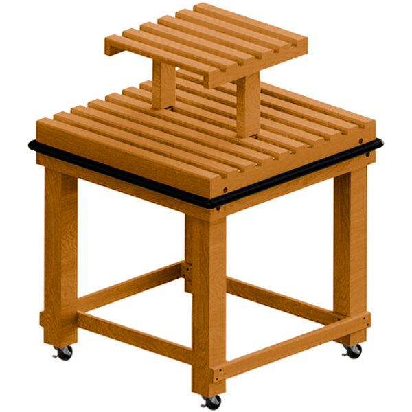 A Marco Company honey pine slat display table with a riser on wheels.
