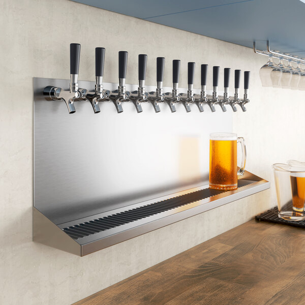 A row of Regency beer taps on a wall with glasses underneath.