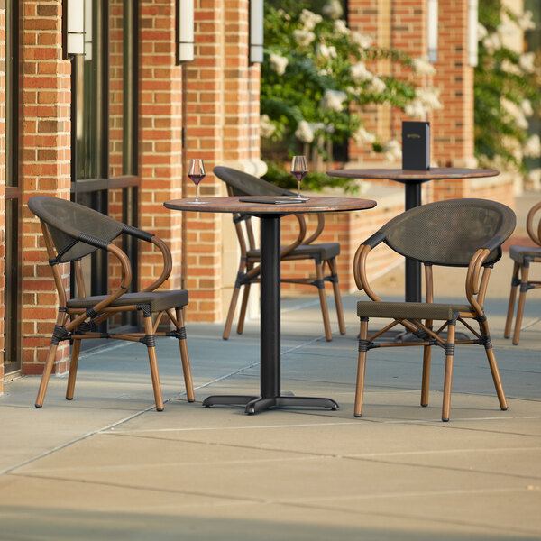 A Lancaster Table & Seating Yukon Oak table and chairs on a patio.