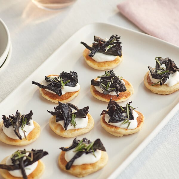 A plate of small appetizers with Dried Black Trumpet Mushrooms.