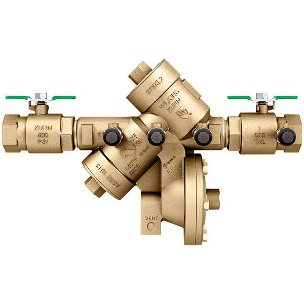 A close-up of a gold Zurn reduced pressure principle backflow preventer with green test fittings.
