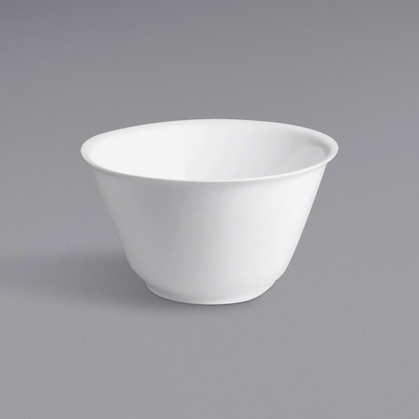 A RAK Porcelain white round salad bowl on a gray surface.