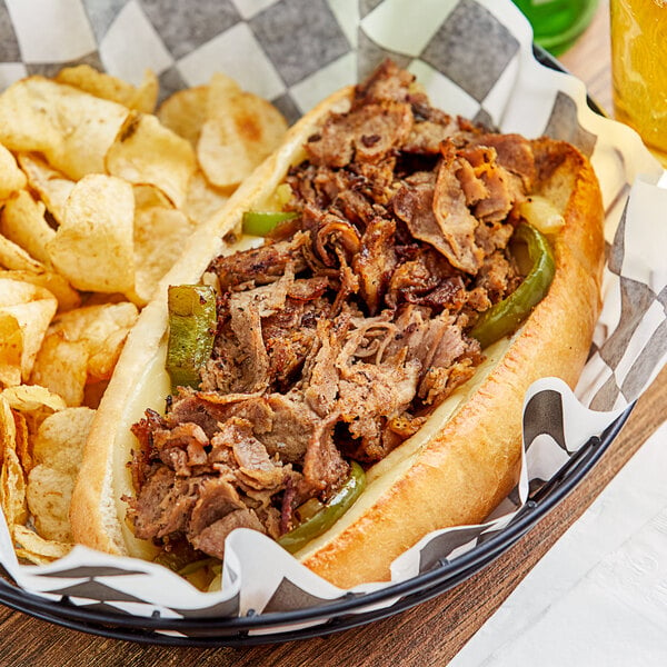 A sandwich with Original Philly Cheesesteak Co. seasoned beef and chips.
