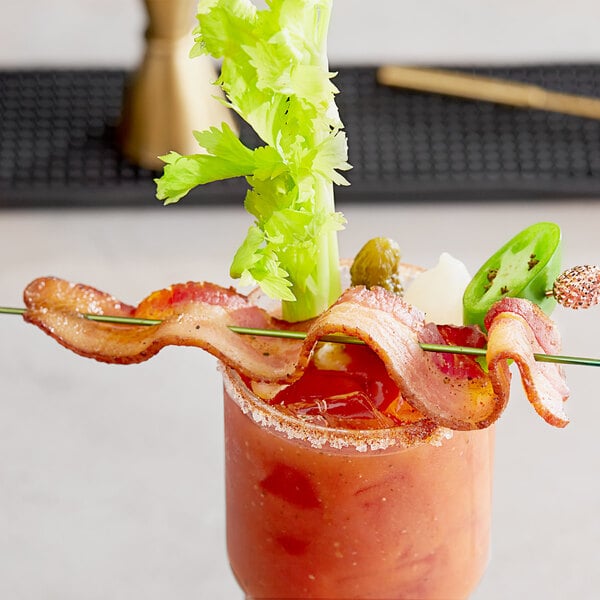 A bloody mary with bacon on a stick in it.