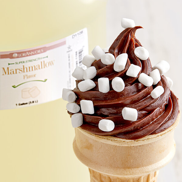 A chocolate ice cream cone with marshmallows on top.