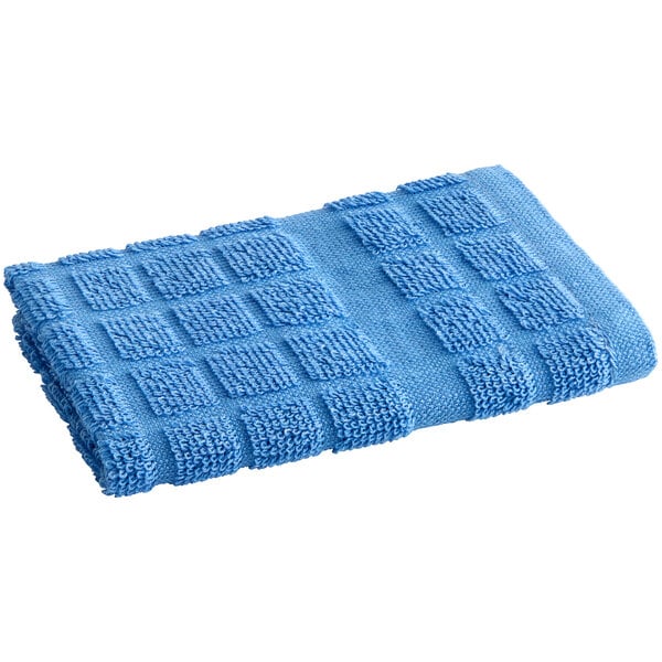 A folded blue Oxford Kitchen Ensemble dish cloth with a square design on a white background.