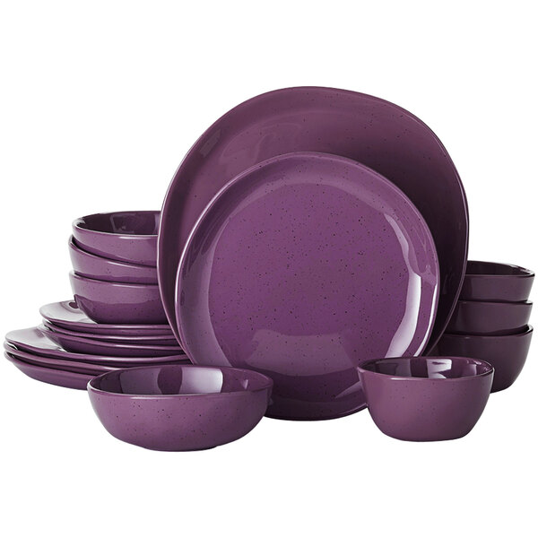 An American Metalcraft Crave Dusk melamine dinnerware set with purple plates and bowls on a table.