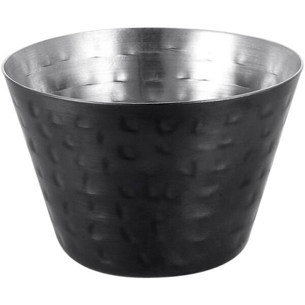 An American Metalcraft black stainless steel sauce cup with a hammered design and silver rim.