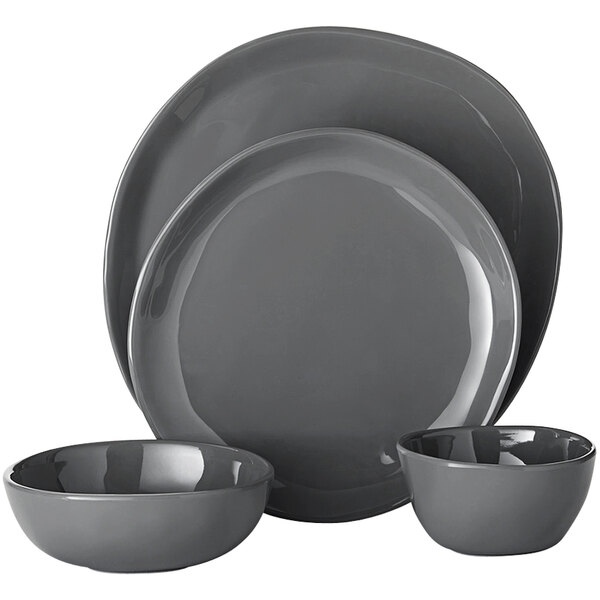 A set of grey plates and bowls, including three bowls and a plate.