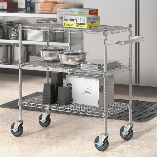 A Regency chrome utility cart with food containers on it.