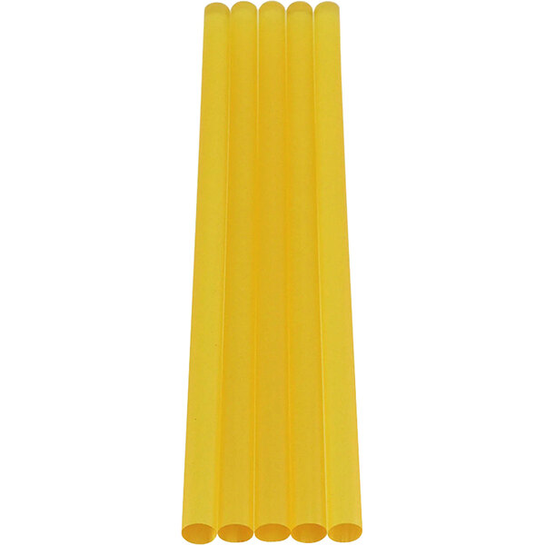 A group of yellow rectangular Surebonder high temp glue sticks on a white background.