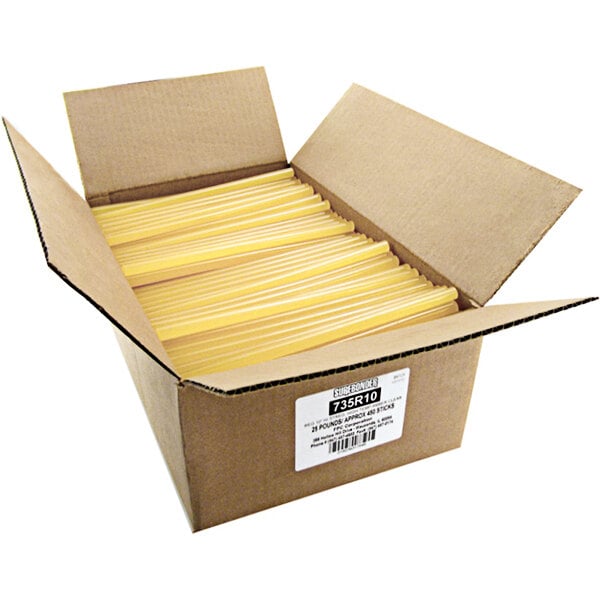 A box full of yellow Surebonder glue sticks with white writing on a yellow background.