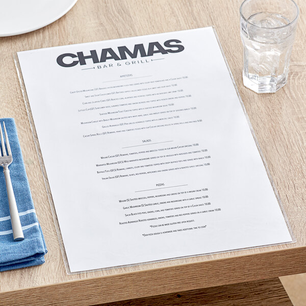 A clear Choice 2-View single pocket menu cover on a table with a place setting and a glass of water with ice.