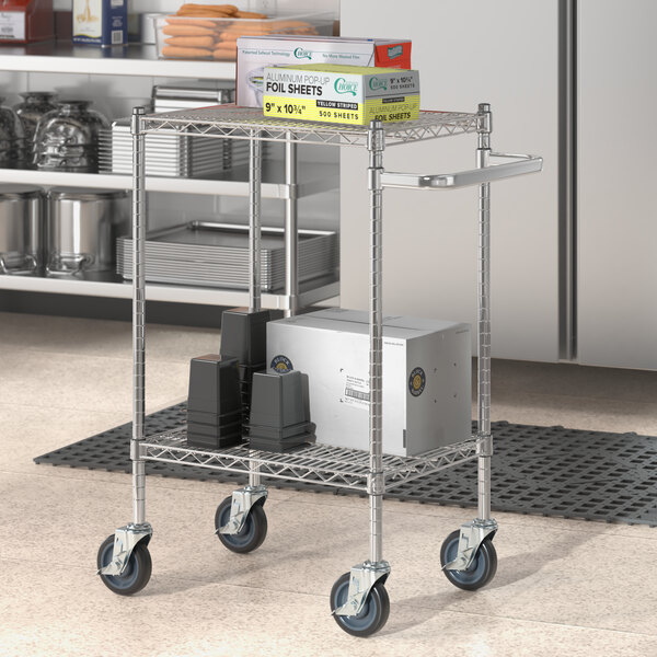 A Regency chrome utility cart with boxes on a shelf.