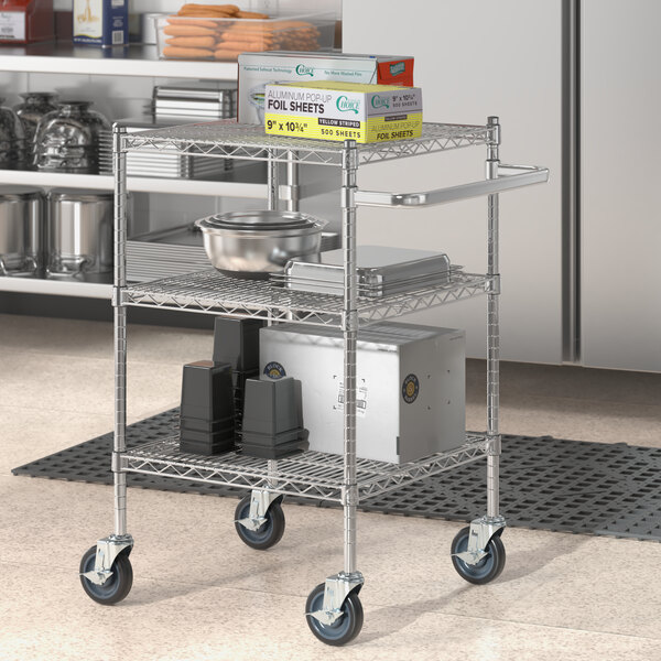 A chrome utility cart with shelves holding food items.