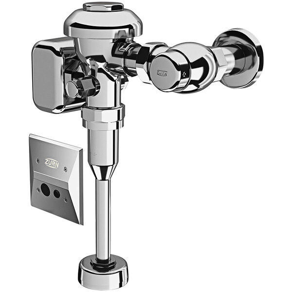 A close-up of a chrome plated Zurn urinal flush valve with a white wall.