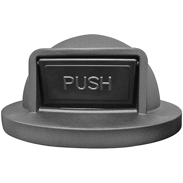 A close-up of a black push door button with a grey push button.