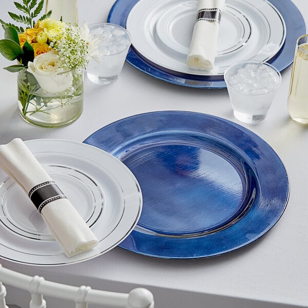 A table set with Choice Royal Blue Charger Plates and glasses.