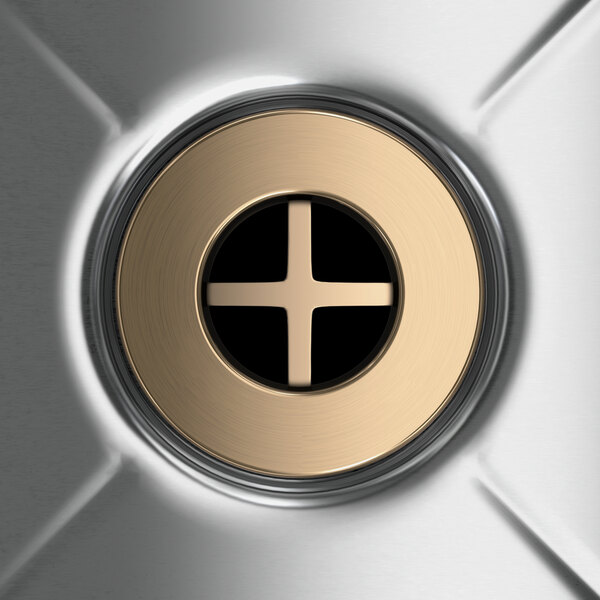 A circular metal blender station with a circular hole and a metal button with a cross in it.