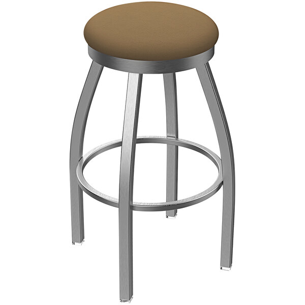 A Holland Bar Stool stainless steel outdoor counter stool with a brown seat.