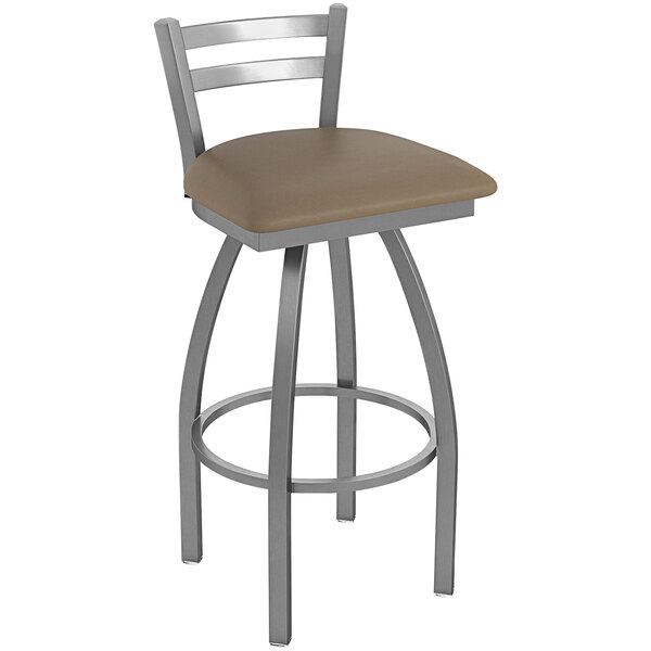 A Holland Bar Stool stainless steel outdoor bar stool with a brown cushion on the seat.
